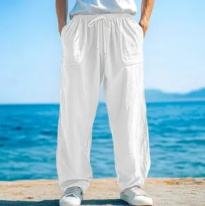 Loose fit white linen beach pants for men with drawstring waist and pockets detail
