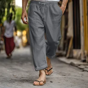 Close-up of men's grey cotton linen pants with elastic drawstring waist and pockets