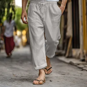 Close-up of lightweight cotton linen pants featuring drawstring elastic waist and pockets.