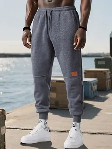Pantalones de chándal ajustados de forro polar gris para hombre con cordón y puños