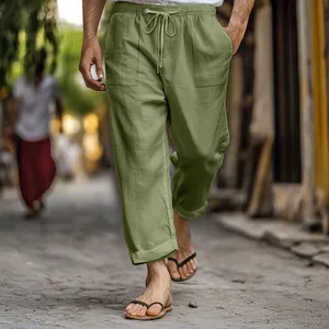 Men's casual olive green cotton linen pants with drawstring waist and pockets in street scene