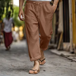 Detail view of men's brown cotton linen pants with drawstring waist and pockets