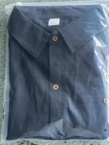 Dark blue 100% cotton men's Hawaiian shirt folded in clear plastic zip-lock bag