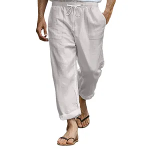 Men's casual white linen pants with drawstring elastic waist and pockets for summer beach.