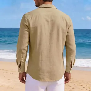 Detailed back view of a men's vintage khaki cotton linen casual long sleeve shirt on a beach