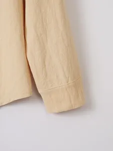 Detailed view of apricot cotton linen shirt cuff showing high quality fabric texture