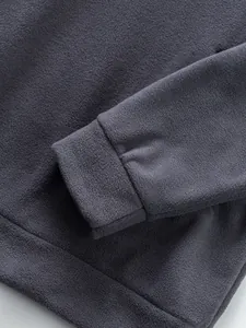 Close-up detail of grey fleece sweatshirt showing cuff and soft fabric texture