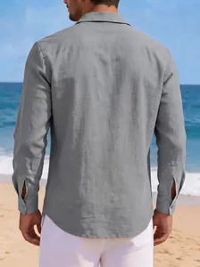 Detailed back view of a men's casual grey cotton linen long-sleeved shirt at the beach