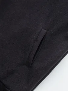Detailed close-up of pocket and soft black fleece texture on men's winter sweatshirt