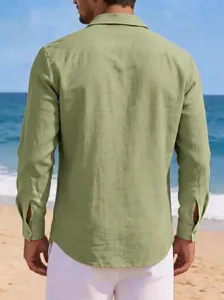 Detailed back view of a men's olive green long sleeve cotton linen casual shirt on beach