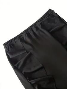 Macro view of black ruffled knit bodycon skirt showing fabric texture and elastic waistband