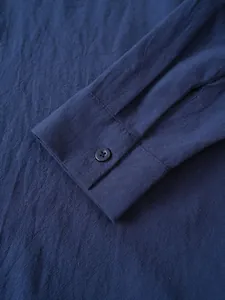 Primer plano detallado del puño de una camisa de algodón y lino para hombre en azul marino
