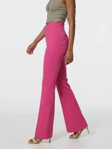 Vista lateral detallada de pantalones de traje acampanados rosa de talle alto en una modelo