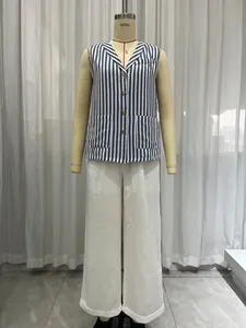 Detailed view of the French blue and white striped vest and white wide-leg trousers