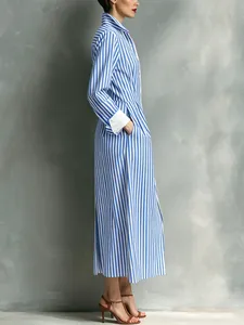 Side view of elegant blue and white striped shirt dress with white cuffs and pockets