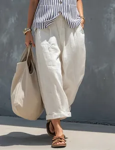 Detail of French blue and white striped vest paired with white linen wide-leg trousers.