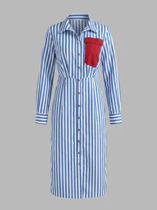 Detailed view of blue white striped shirt dress featuring a contrast red pocket.