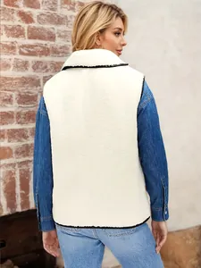 Rear view of white lamb wool vest with contrast black piping over a denim shirt.