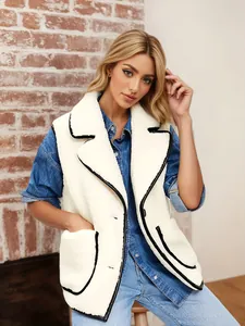 Detail view of stylish white faux shearling vest with black contrast piping and lapel