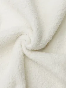 Macro view of soft white sherpa fleece material showing thick cozy texture