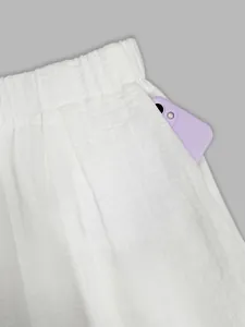 Detail view of side pocket on white wide-leg trousers showing functional storage space