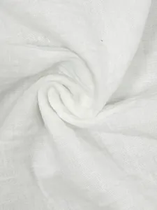 Close-up detail of soft breathable white linen fabric texture for summer clothing set.
