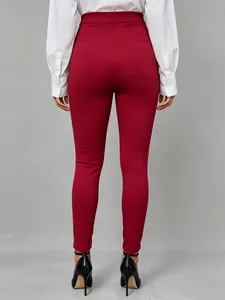 Back view of burgundy slim fit stretch trousers for women in a professional style
