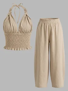 Detail van Boheemse linnen haltertop en losse lantaarnbroek tweedelige set in beige.