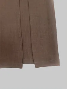 Close-up detail showing the high-slit hemline and fine stitching of a brown long skirt