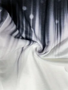 Detail view of soft knitted fabric with black and white gradient print for sweatpants.
