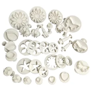 Comprehensive 33-piece white fondant cutter set with various floral and leaf shapes.