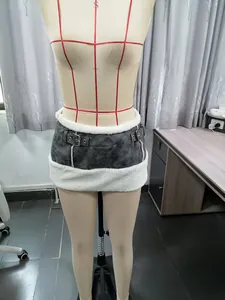 Detail view of Y2K low waist PU mini skirt with white shearling trim on mannequin.