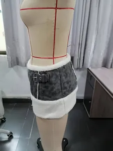 Close-up detail of Y2K grey PU mini skirt featuring soft white plush trim and buckle