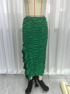 Detailed view of green ruched asymmetrical maxi skirt with ruffled hem on mannequin