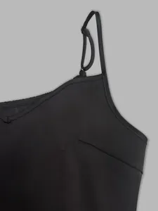 Macro detail shot showing the adjustable shoulder strap of a black camisole dress.