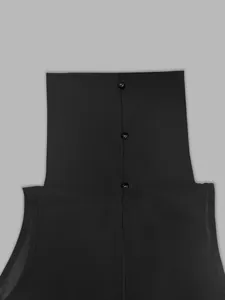 Close-up of the high neck back buttons on a black sleeveless French style dress.