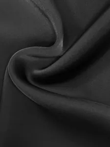 Close-up macro shot of elegant black mesh fabric texture with fine woven details.