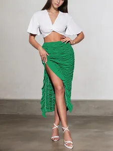 Detailed view of a green ruched summer skirt featuring an asymmetric ruffled hem
