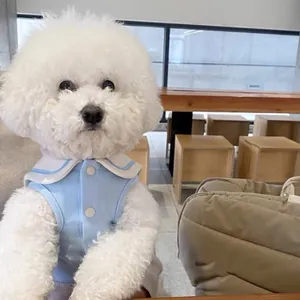 Detailed view of light blue pet shirt with white sailor collar on a white dog