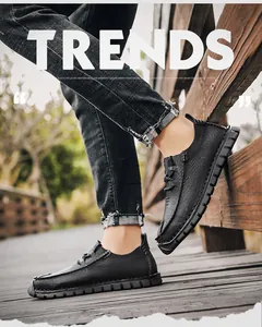 Close-up detail of men's black casual leather shoes worn on a rustic outdoor wooden bridge
