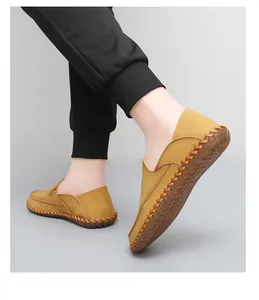 Detail view of men's hand-stitched loafers with soft rubber soles for driving.