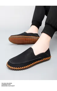 Close-up detail of black handmade loafers with orange stitching and beef tendon sole