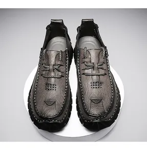 Top-down view of men's brown textured leather shoes with thick stitching details