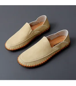 Exquisite detail of orange handmade stitching on beige leather men's driving loafers shoes