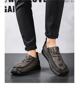 Close-up detail of men's casual brown leather shoes with durable stitching and lace-up closure