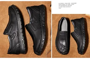 Detailweergave van handgemaakte zwarte leren loafers met stikseldetails op bruine achtergrond