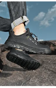 Detailed view of men's black leather hiking shoes with durable anti-slip rubber sole