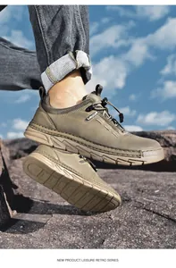 Durable men's khaki hiking shoes shown on rocky terrain outdoors.