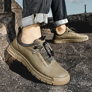 Men's durable khaki outdoor hiking shoes with casual leather finish on rocky terrain