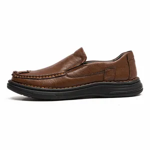 Side view of brown leather loafer showing detailed stitching and soft black rubber sole.
